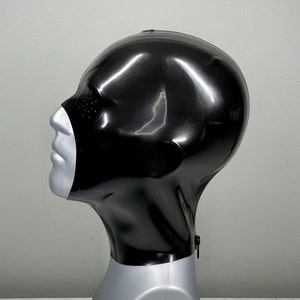 May include: A black latex hood with a zipper closure and eye holes. The hood is displayed on a mannequin head.