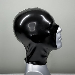 May include: A black latex hood with a zipper at the neck. The hood is on a mannequin head.