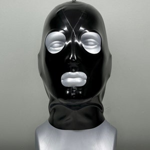 May include: A black latex mask with eye and mouth openings. The mask is on a gray mannequin head.