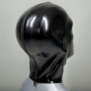 May include: Black latex hood with a zipper down the back. The hood is on a mannequin head.