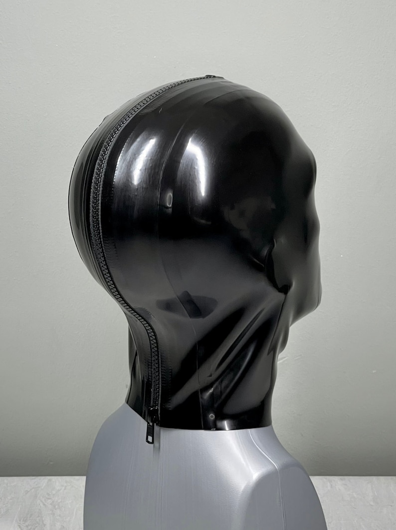 May include: Black latex hood with a zipper down the back. The hood is on a mannequin head.