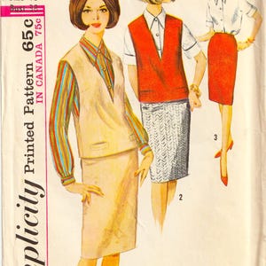 May include: A Simplicity sewing pattern envelope, number 5601, size 18, bust 38. The illustration shows three outfits: a beige vest and skirt with a striped shirt, a red vest with a patterned skirt and white shirt, and a red skirt with a white shirt.