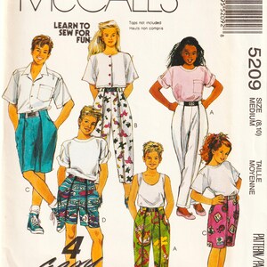 May include: McCall's sewing pattern featuring illustrations of various outfits, including shorts, pants, and tops. The pattern includes the text "Learn to Sew for Fun" and "4 Easy Pieces". The size is medium (8,10).