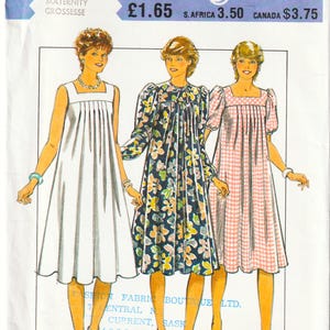 May include: A sewing pattern envelope labelled 3849 Style featuring illustrations of three maternity dresses. One is solid white, one has a dark blue floral print, and one has a pink and white gingham check pattern. The envelope includes text.