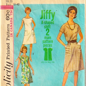 May include: Simplicity pattern 5960 for a Jiffy A-shaped shift dress. The envelope features illustrations of three dress variations: a solid white dress with pockets, a green and blue floral print dress, and a brown and white striped dress with a belt.