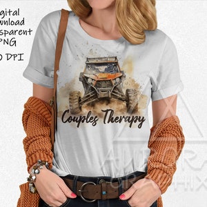 May include: White t-shirt with a watercolor illustration of an orange off-road vehicle and the text "Couples Therapy".