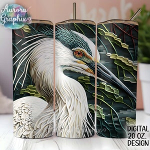 May include: A 20 oz. stainless steel tumbler with a white heron design. The heron's head and neck are in focus, with its body and wings partially visible. The background is a dark green and blue pattern.