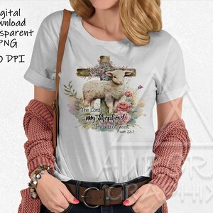 May include: White t-shirt featuring a watercolor design of a lamb, cross, and flowers. The text "The Lord is my Shepherd, I shall not want, Psalm 23:1" is also printed on the shirt. Digital download, transparent PNG, 300 DPI.
