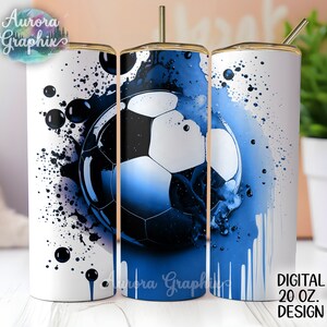 May include: A white 20 oz tumbler with a blue and black soccer ball graphic. The graphic has a watercolor effect with blue paint splatters and drips.
