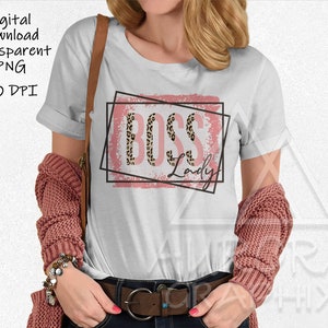 May include: White t-shirt with a pink and black graphic that says "Boss Lady" in leopard print.