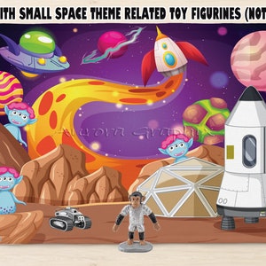 May include: A colorful space-themed play scene backdrop with planets, a rocket, and a spaceship. The backdrop is perfect for use with small space-themed toy figurines (not included).