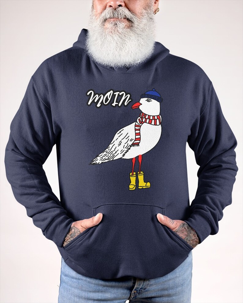 May include: A navy blue hoodie with a white seagull wearing a blue hat, red and white scarf, and yellow rain boots. The word "Moin" is printed in white above the seagull.