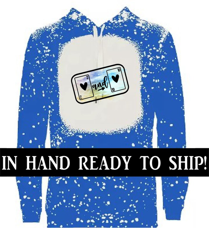May include: Blue hoodie with a white splatter pattern and a graphic of two playing cards with hearts and the word "and" on them.