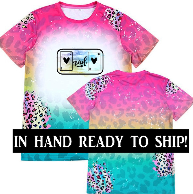 May include: Pink and blue ombre t-shirt with a leopard print design. The shirt features a graphic of a slot machine with hearts and the word "and".