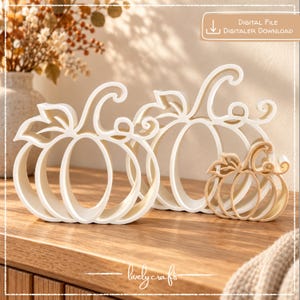 May include: Three white and beige pumpkin-shaped cutouts with curved stems and leaf details. The text "DIGITAL FILE DIGITALER DOWNLOAD" appears in the top right corner, and the text "lovely crafts" is centred at the bottom of the image.