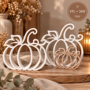 Puede incluir: Tres adornos decorativos con forma de calabaza y diseños de marco abierto. Dos calabazas más grandes son blancas y una más pequeña es de color marrón claro. Una insignia circular en la esquina superior derecha muestra el texto STL + 3MF con un icono de corazón.