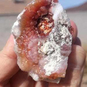 May include: A set of three ceramic mugs with a speckled, matte finish. The mugs are in shades of cream, light brown, and dark brown. Each mug has a simple, minimalist design and a rounded handle.