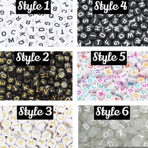 May include: Six different styles of letter beads. The beads are white, black, clear, and white with gold lettering. The beads are arranged in six groups, each with a different style. The styles are labelled "Style 1", "Style 2", "Style 3", "Style 4", "Style 5", and "Style 6".