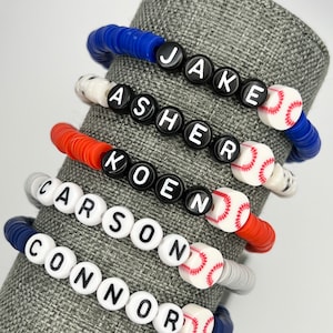 May include: Five colorful beaded bracelets with baseball charms. The bracelets spell out the names Jake, Asher, Koen, Carson, and Connor.