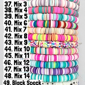 May include: A stack of colourful round beads, labelled with numbers 35 to 52. The beads are arranged in rows, with each row labelled with a different mix number or type of bead. The beads are made of plastic and have a variety of colours, including pink, blue, green, yellow, and white.
