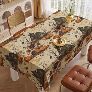May include: A rectangular tablecloth featuring a repeating Halloween-themed pattern on a cream background. The design includes dark haunted houses, orange pumpkins, bare tree branches, black crows, and autumn leaves under a full moon.