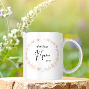 May include: A white ceramic mug with a black handle and the text "But First, Coffee" in a bold, black font. The mug is likely 11-15 ounces, perfect for a morning beverage. The design is simple and modern.