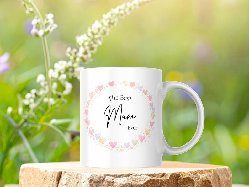 May include: A white ceramic mug with a black handle and the text "But First, Coffee" in a bold, black font. The mug is likely 11-15 ounces, perfect for a morning beverage. The design is simple and modern.