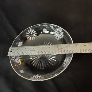 May include: A clear glass dish with a starburst pattern. The dish is approximately 7 inches in diameter.