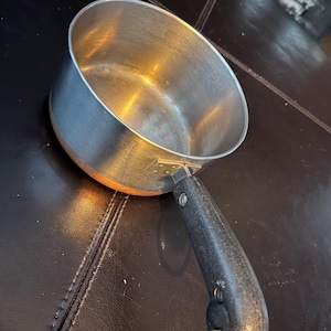 May include: A set of three ceramic mugs with a speckled, matte finish. Each mug is a different colour: light blue, cream, and grey. The mugs have a simple, modern design and a comfortable handle.