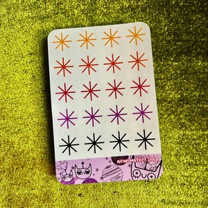 May include: A sheet of colorful star stickers with a variety of colors including orange, red, purple, and black. The sheet has the text "neon mothership" at the bottom.