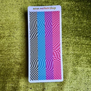 May include: A rectangular sticker with a colorful checkerboard design. The sticker features vertical stripes of black and white, blue, purple, and pink checkered patterns. The text "neon mothership" is at the top of the sticker.