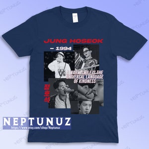 May include: Navy blue t-shirt featuring a collage of black and white images of Jung Hoseok. The shirt includes the text "JUNG HOSEOK - 1994" in red, and the quote "A WARM SMILE IS THE UNIVERSAL LANGUAGE OF KINDNESS". The shop name "NEPTUNUZ" is also visible.