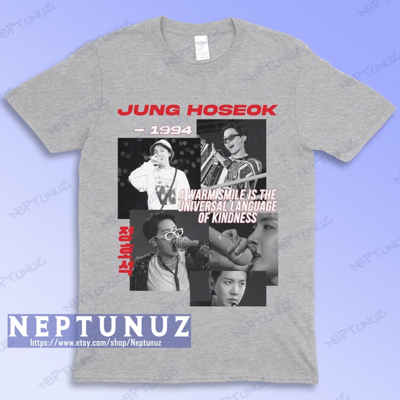 May include: A gray t-shirt featuring a collage of black and white images of Jung Hoseok, with the text "JUNG HOSEOK - 1994" in red. The shirt also includes the quote "A warm smile is the universal language of kindness."