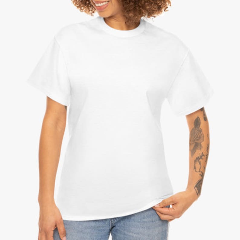 May include: A plain white t-shirt with a crew neck and short sleeves. The shirt is made of a soft, opaque material. The model is wearing blue jeans.