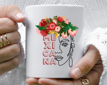 May include: White ceramic mug with a black line drawing of a woman's face wearing a floral crown. The word "MEXICANA" is written vertically in red and pink letters.