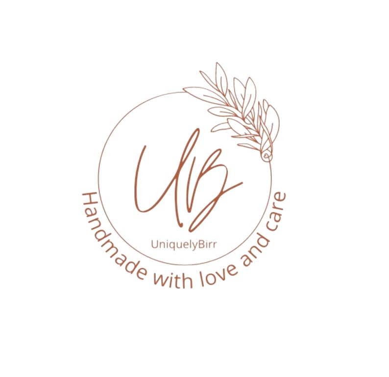 May include: A brown circle logo with the text "Handmade with love and care" surrounding the letters "UB" in a cursive font. The text "UniquelyBirr" appears below the letters. A stylized floral design appears above the letters.