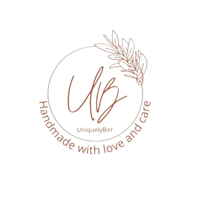 May include: A logo design featuring the initials "UB" in a handwritten style, enclosed within a circular frame. The logo includes the text "Handmade with love and care" and "UniquelyBirr" in a soft brown color, with a decorative leaf element.