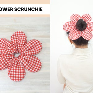 View of flower hair scrunchie on table and worn over hair bun