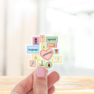 May include: A clear sticker featuring a collage of colorful illustrations and text related to speech pathology. The sticker includes the words "language," "speech," and "pathology," along with various related images. The sticker is held up by a person's hand.