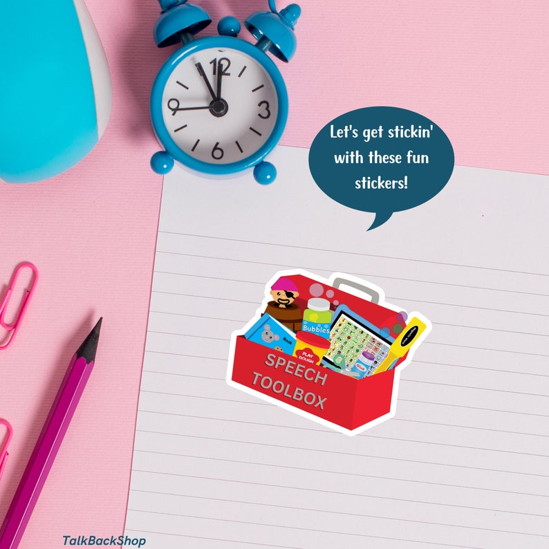A sticker that says speech toolbox is place on a white piece of notebook paper.  The image includes a red toolbox with various speech therapy toys and tools.