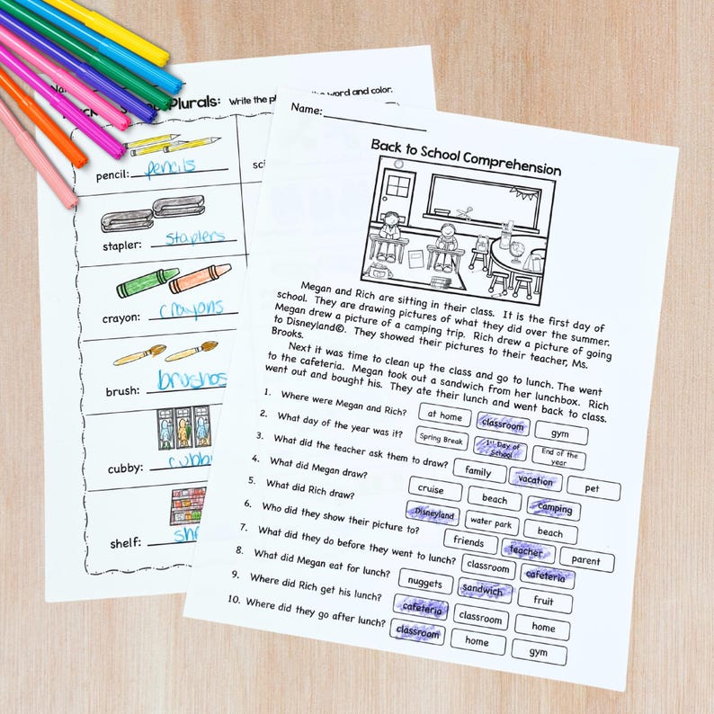 May include: Two worksheets with school-themed exercises are on a light wood surface. One worksheet focuses on plurals, the other is a reading comprehension activity. Colored pencils are in the upper left corner. The text includes "Back to School Comprehension".