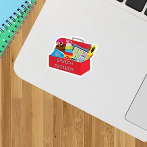 May include: A red toolbox with the words "Speech Toolbox" on the front. The toolbox is filled with various speech therapy tools, including a pirate puppet, bubbles, a picture card deck, and a play dough set.