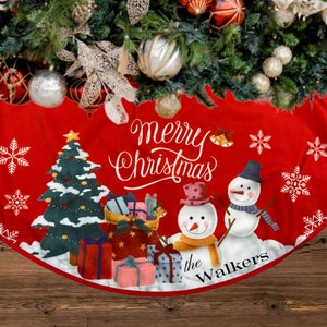 May include: Red Christmas tree skirt with a snowman and Christmas tree design. The text "Merry Christmas" and "the Walkers" is printed on the skirt.