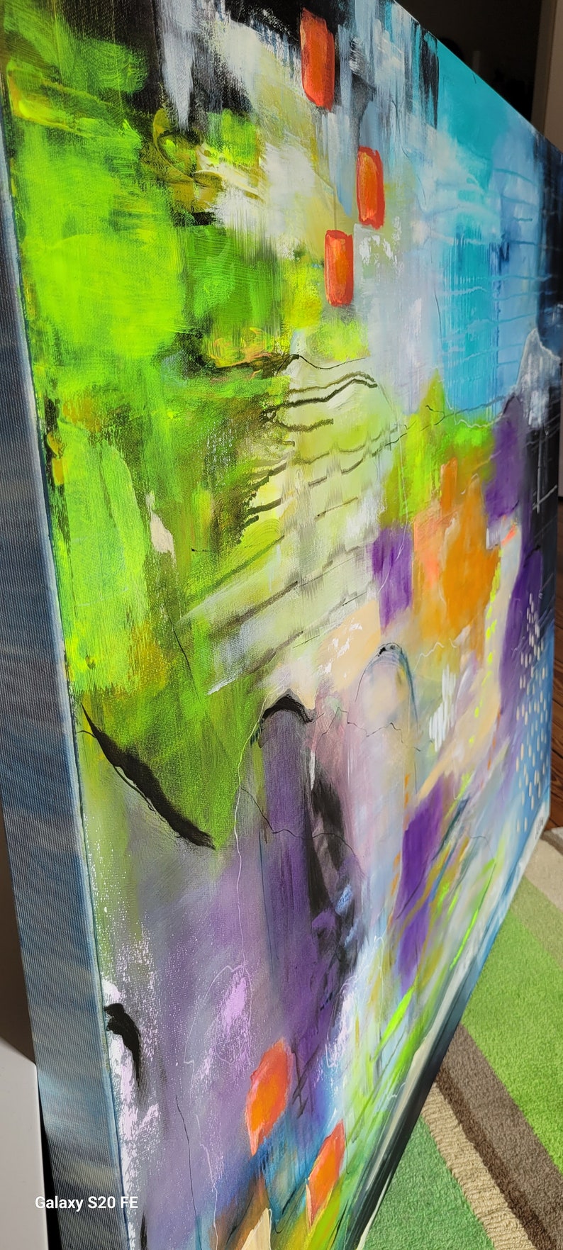 May include: Abstract painting with vibrant colors, including green, purple, blue, and orange. The painting features bold brushstrokes and a dynamic composition.