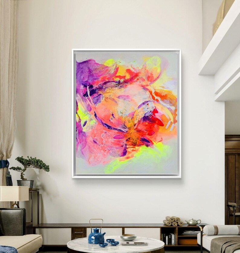 May include: Abstract painting with vibrant colors, including pink, purple, orange, and yellow, on a gray background. The painting has a fluid and dynamic style, with swirling and overlapping shapes.