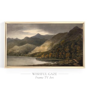 May include: A framed landscape painting depicting a lake and mountain scene. The artwork is in a gold frame and includes the text "WISHFUL GAZE Frame TV Art". The painting evokes a sense of tranquility.
