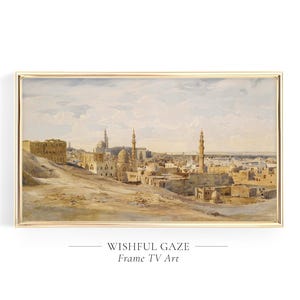 Może przedstawiać: Akwarela przedstawiająca panoramę miasta z widokiem na linię horyzontu z minaretami i budynkami. Obraz jest oprawiony w złotą ramę i ma jasnobrązowe tło.