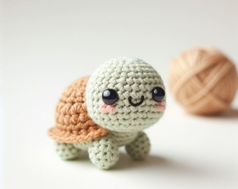 May include: A small crocheted turtle toy with a green shell and brown legs. The turtle has a smiling face with black eyes and pink cheeks.