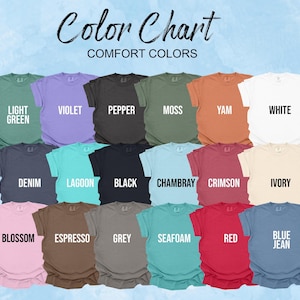 a collection of t-shirts in various colors, including green, purple, orange, white, black, lavender, mint, and teal.