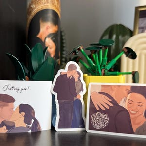 May include: Three stickers and a card featuring illustrations of couples kissing. The card reads "Just say yes!" and one sticker says "Where's the Keys?" The illustrations are in a soft, romantic style, with warm color tones.